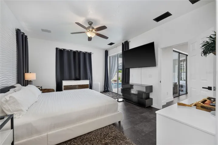 Spacious primary bedroom with a scenic view of the pool.