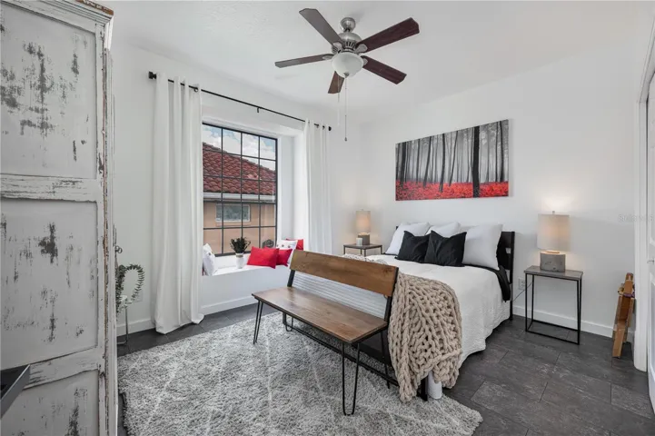 The charming window seat in this secondary bedroom is the perfect spot to read a book.
