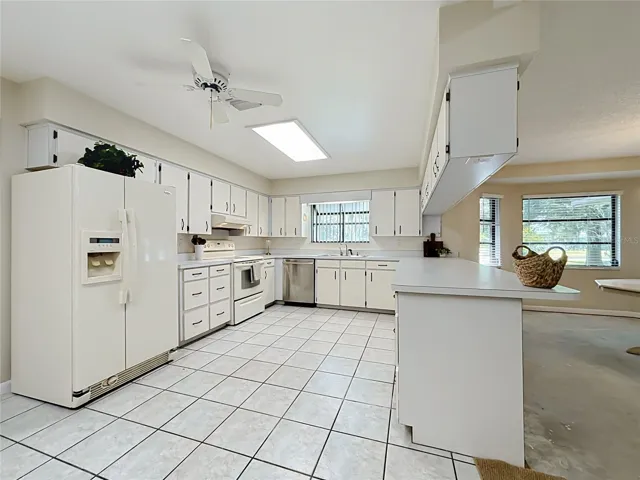 Kitchen features ceramic tile flooring