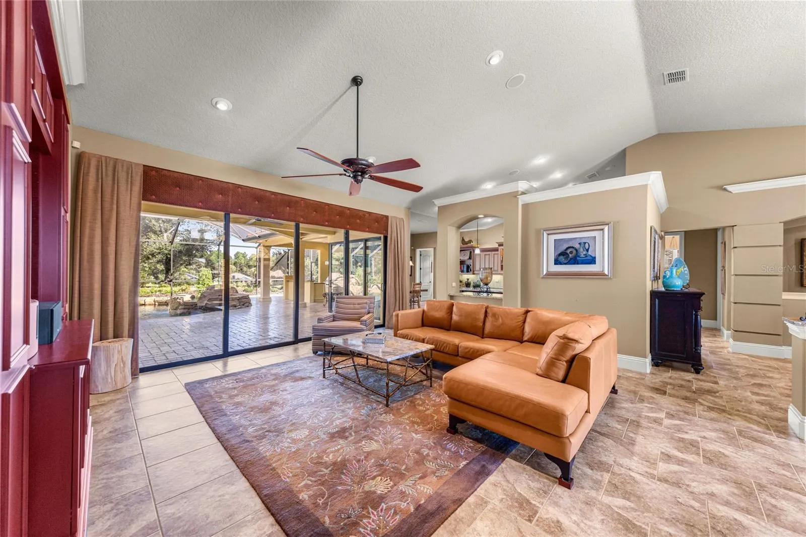Recessed lighting, ceiling fan, and seamless across to the outdoor area.
