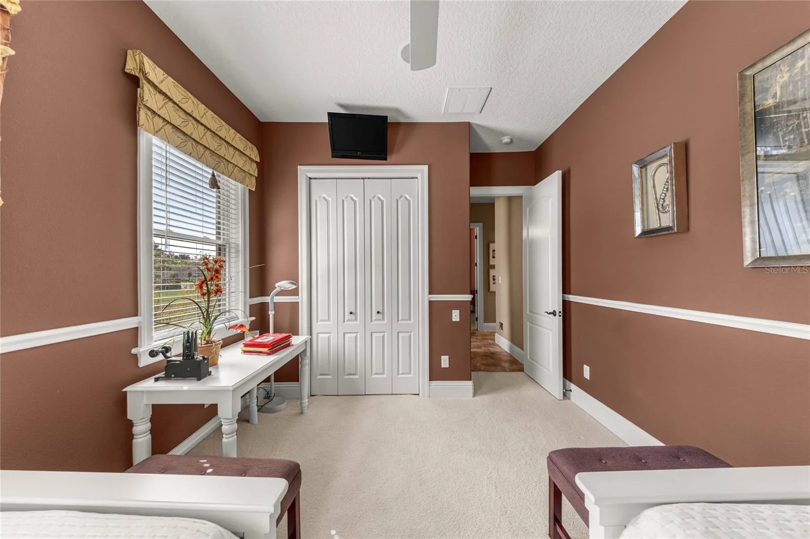 Another perspective of this versatile bedroom, highlighting its spacious layout, closet storage, and natural light.