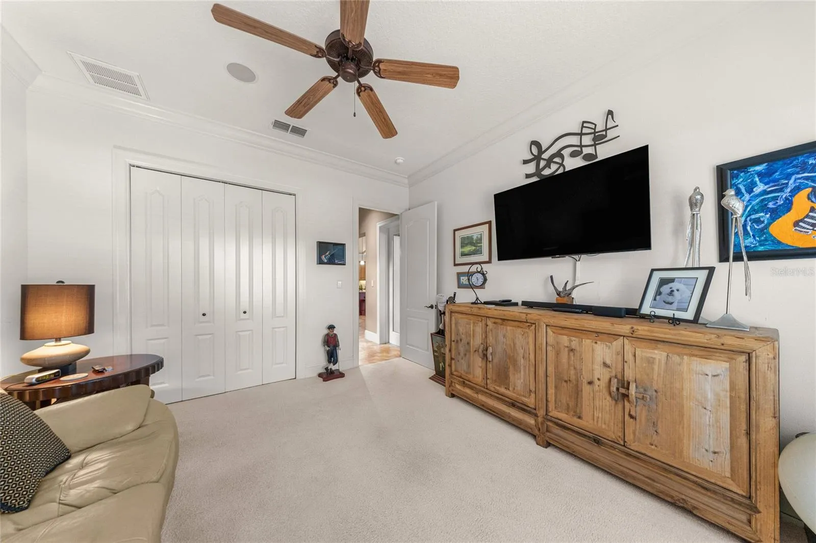 Additional bedroom abundant natural light, ceiling fan, and generous closet space.