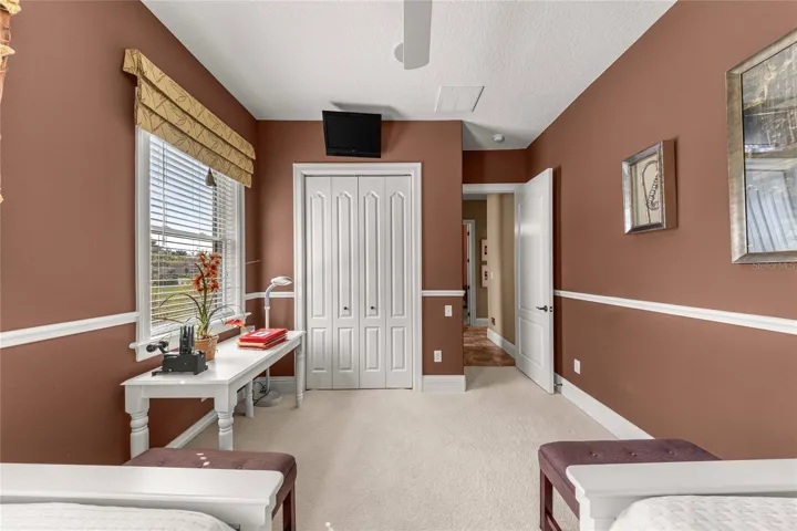 Another perspective of this versatile bedroom, highlighting its spacious layout, closet storage, and natural light.