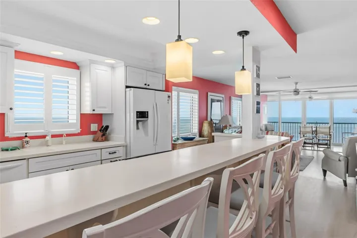 The kitchen includes a bar for dining as well.
