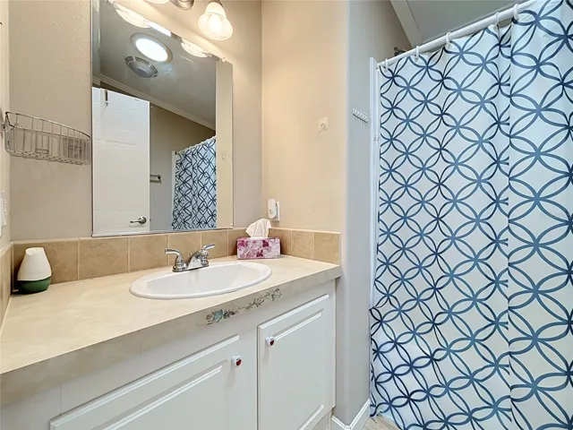 Guest bathroom sits conveniently in the hallway between the dining area and bedrooms