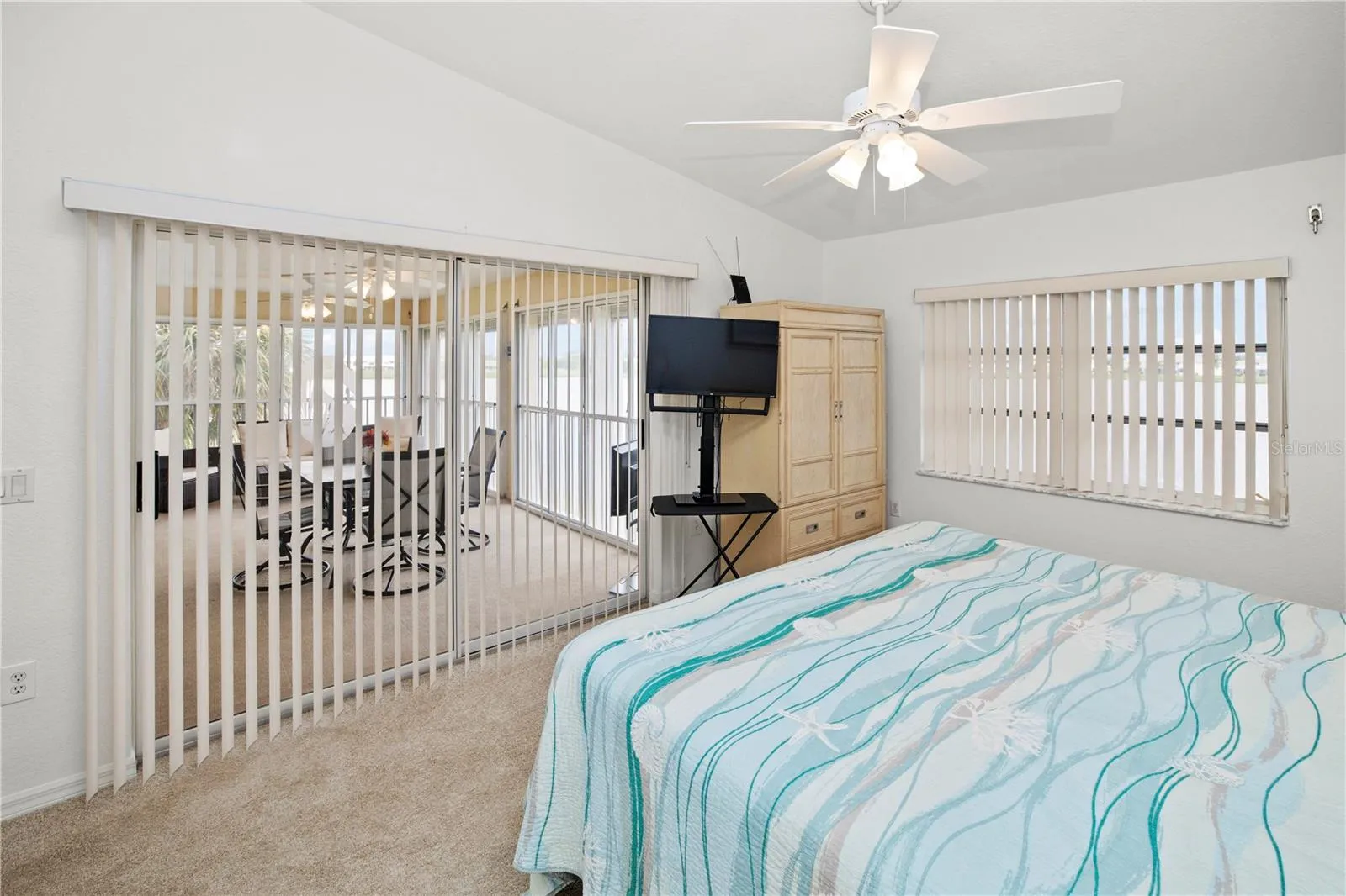 Spacious 12' x 16' Primary Bedroom with Gorgeous Lake Views and Sliders out to the Relaxing Lanai