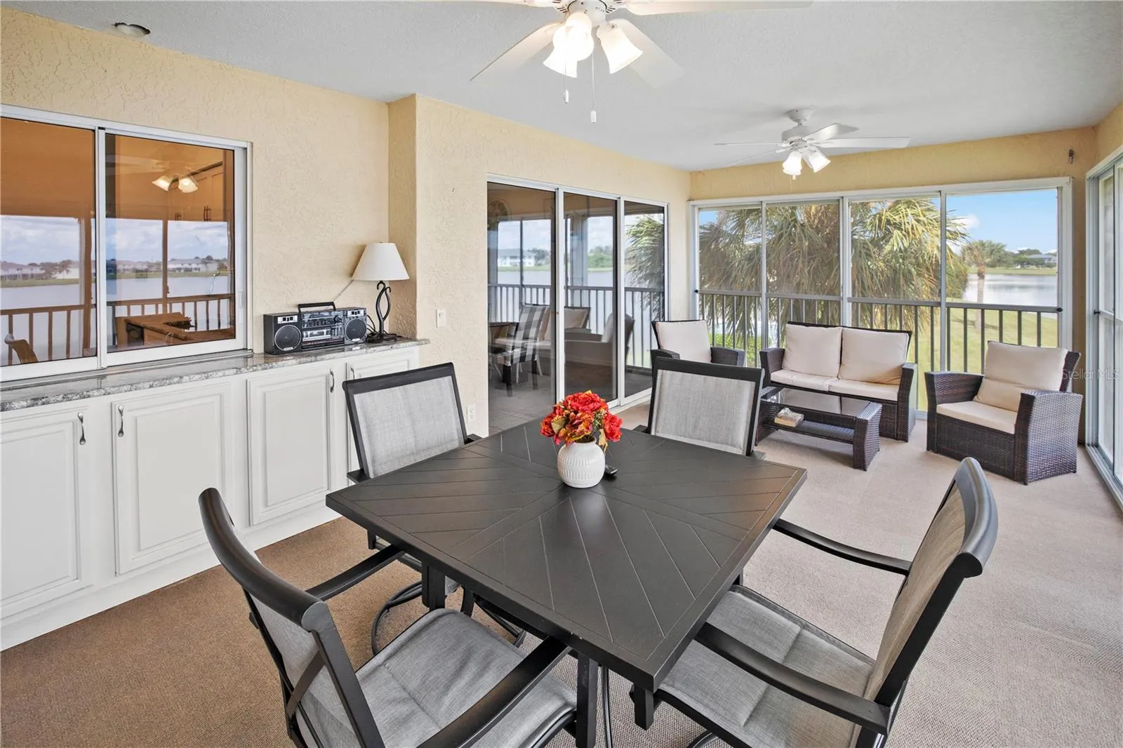 Impressive 20ft, 4 Season, Screened Lanai with Roll Down Shutters and Lake Rio View