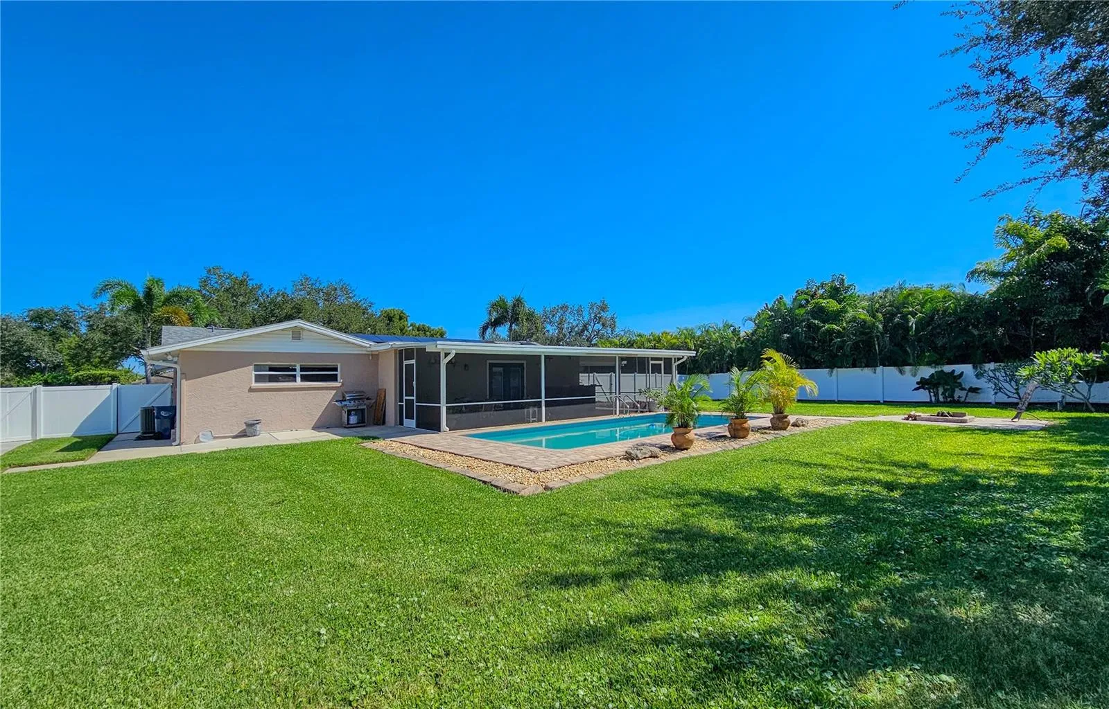 Backyard view of pool and Florida Room