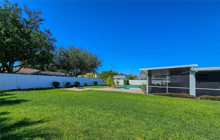Large side yard behind 6' vinyl privacy fence, room to roam