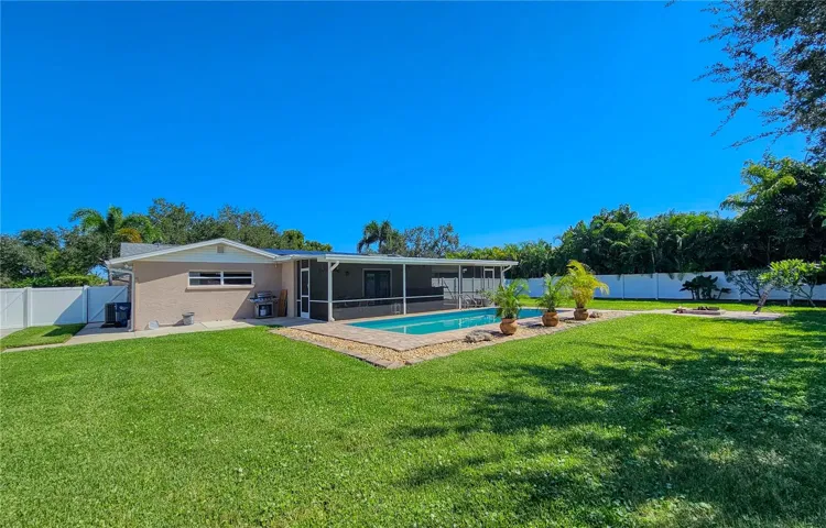 Backyard view of pool and Florida Room
