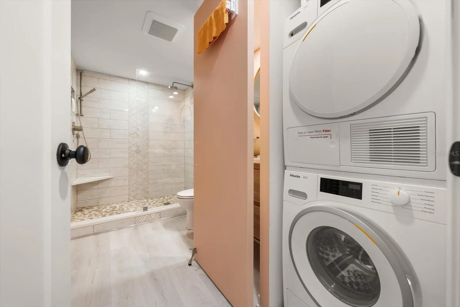 In unit Miele washing machine &amp; dryer; discreetly tucked away in the guest bath.