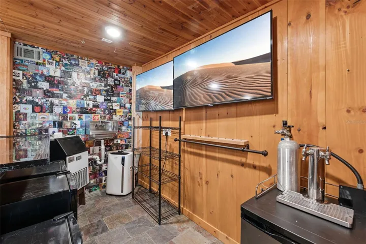 Another view of the bar set up with Ice Machine, Air conditioner, Sink, Kegerator, Wine Fridge and 2 additional fridges for your cans and glassware.   This space is ready to entertain !