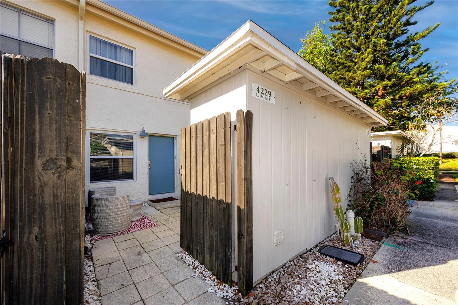 Private fenced back patio with storage closet.