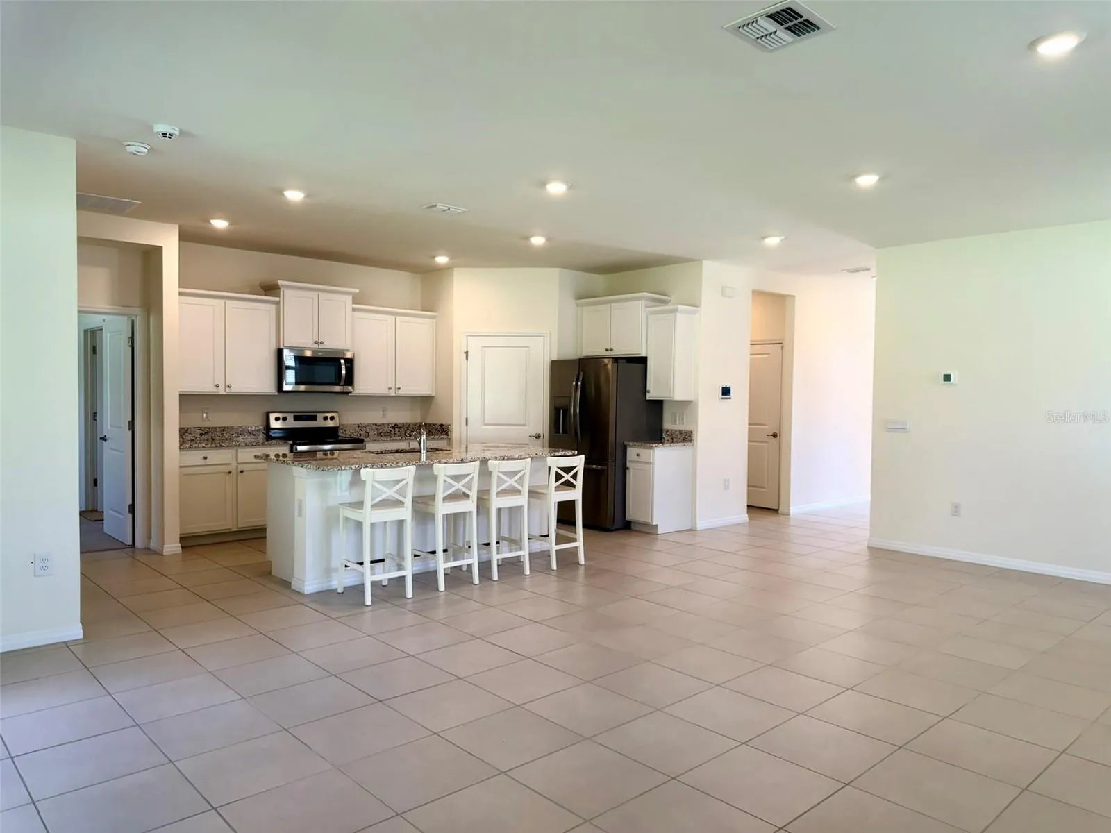 High ceilings and gourmet kitchen with granite countertops.