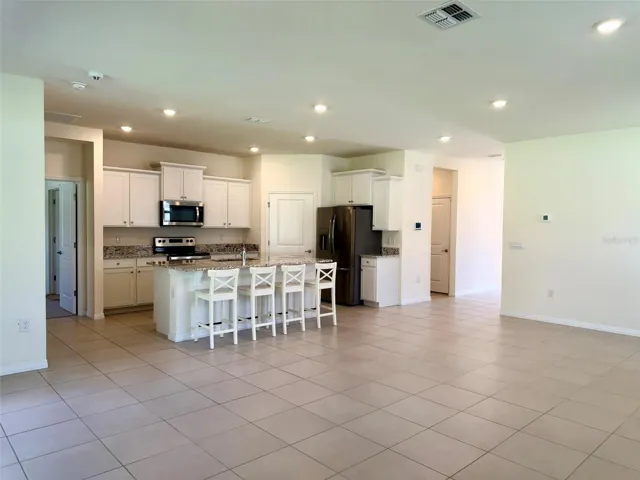 High ceilings and gourmet kitchen with granite countertops.