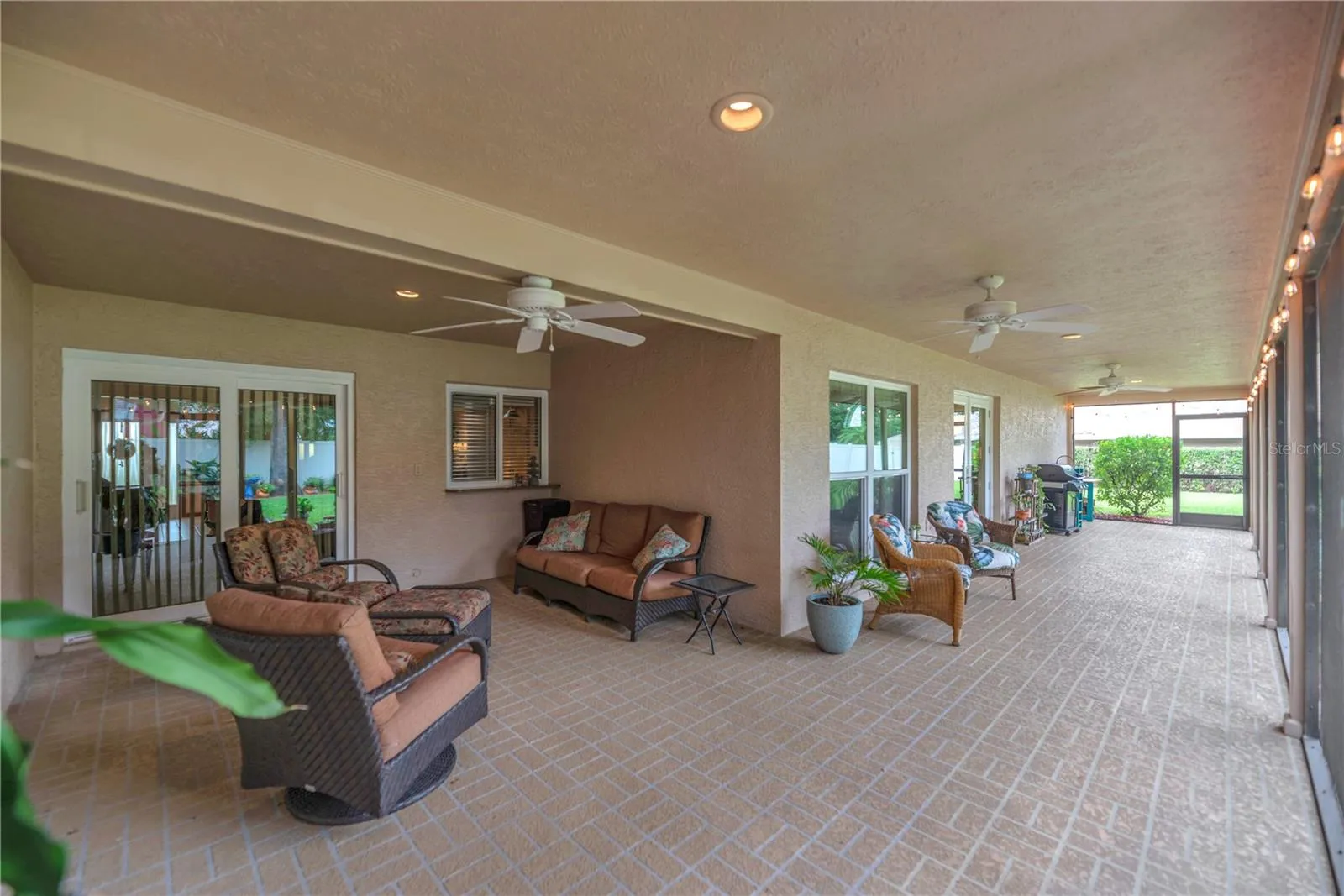 The inviting screened lanai is the perfect spot for morning coffee, evening conversations, and enjoying the peaceful surroundings.