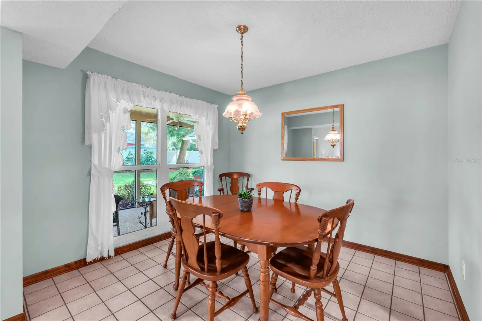 A casual dinette just off the kitchen offers a lovely view of the park-like backyard setting.