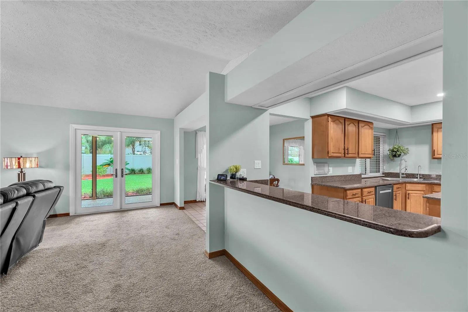 A spacious breakfast bar separates the kitchen from the family room, making it ideal for serving appetizers while entertaining family and friends.