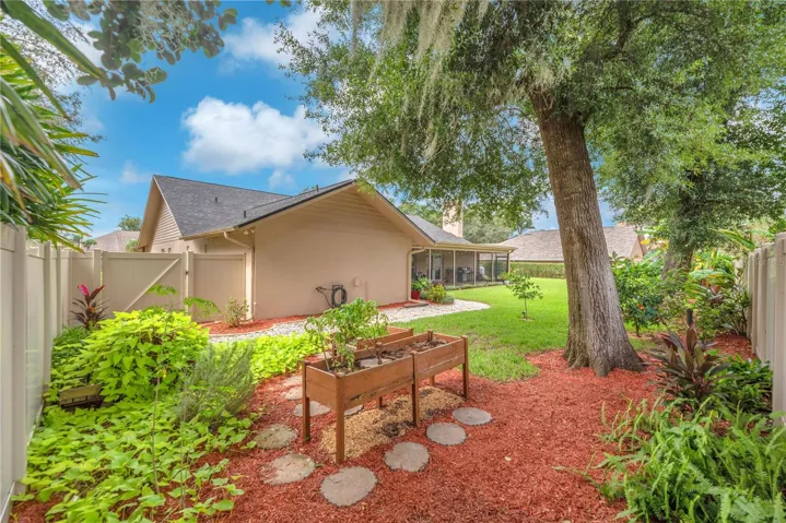 The backyard is partially enclosed with low-maintenance PVC fencing for added privacy and easy upkeep.