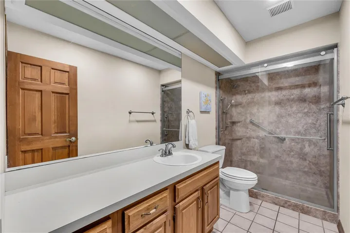 The secondary bedrooms share this hall bathroom with large walk-in shower and vanity with lots of storage.