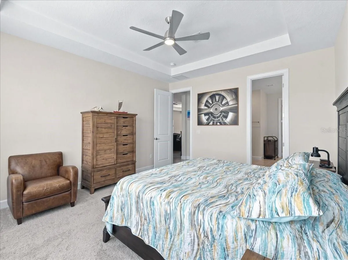 The Owner's suite has shutters and shades as well. There is a view of the pond from the bedroom.