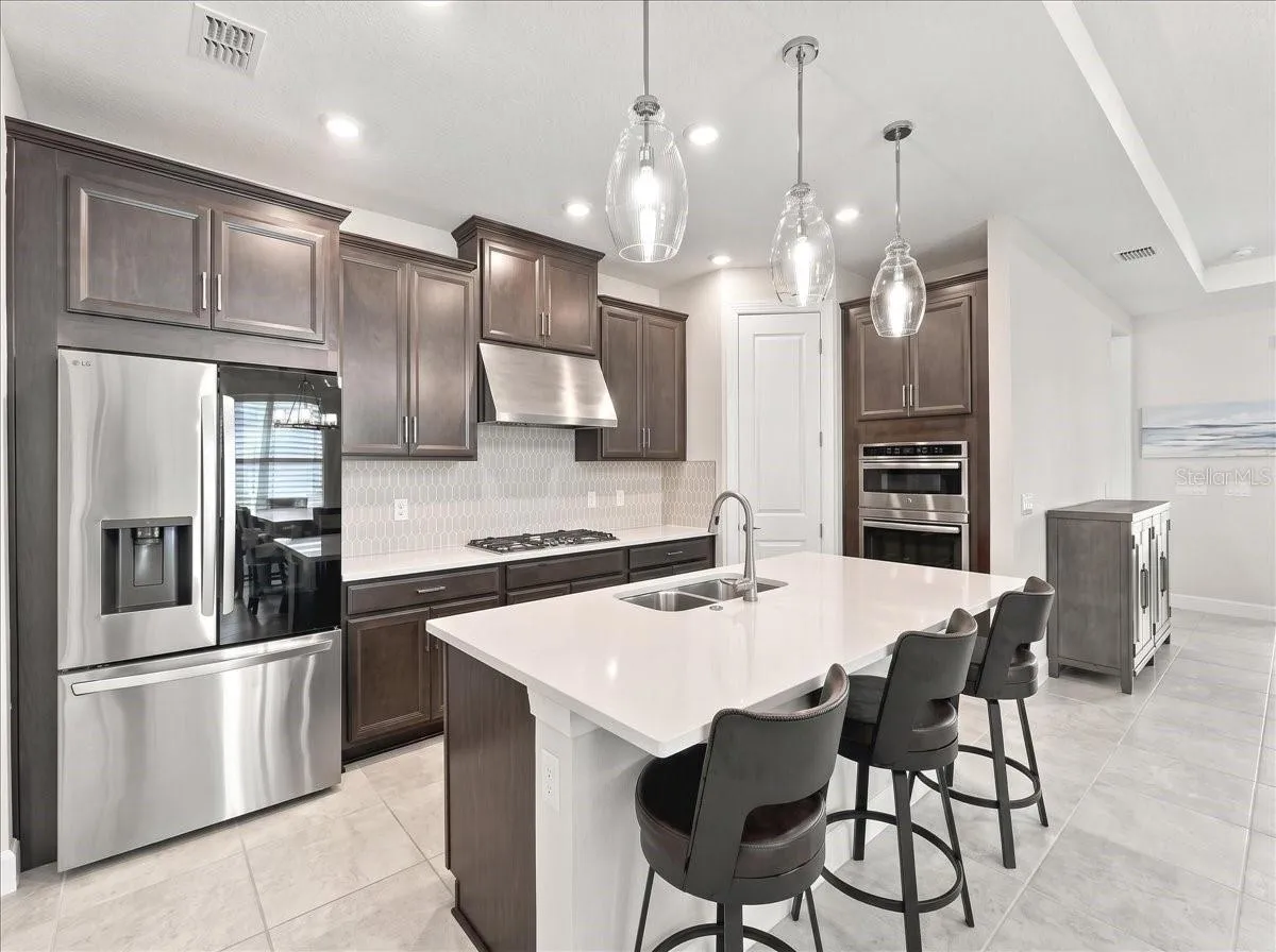 The gourmet kitchen is the heart of the home. There is a built-in oven/microwave, cooktop with hood and a spacious walk-in pantry.