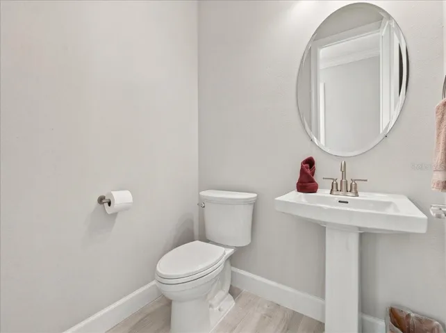 The half bath is conveniently located right inside the front of the home for guests.