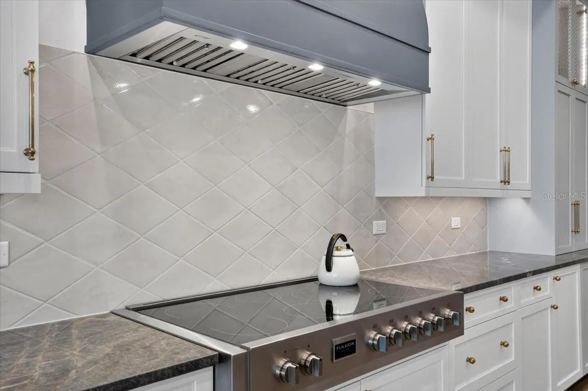 7-burner, 48" Fulgor Milano induction range and custom wood hood