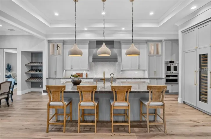 Dovetail Wood Cabinetry with Display Shelving.  Designer pendants.
