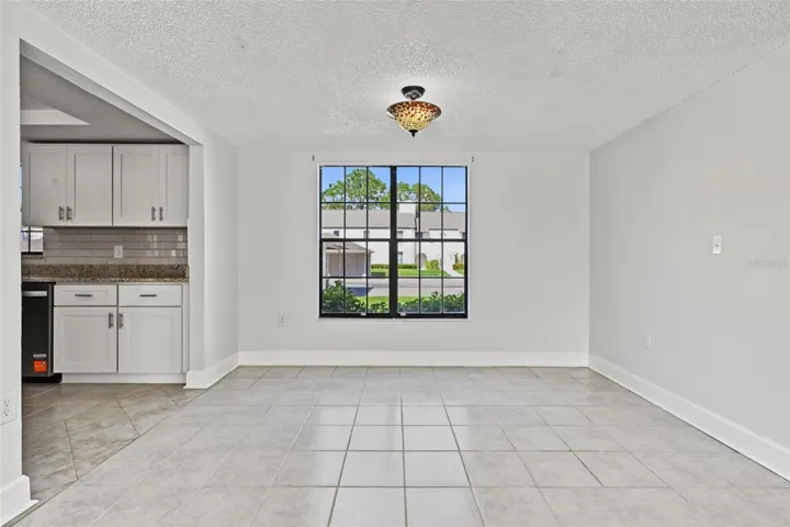 The Dining Area is just off the Kitchen and overlooks the Living Room.  The windows truly provide significant natural light.