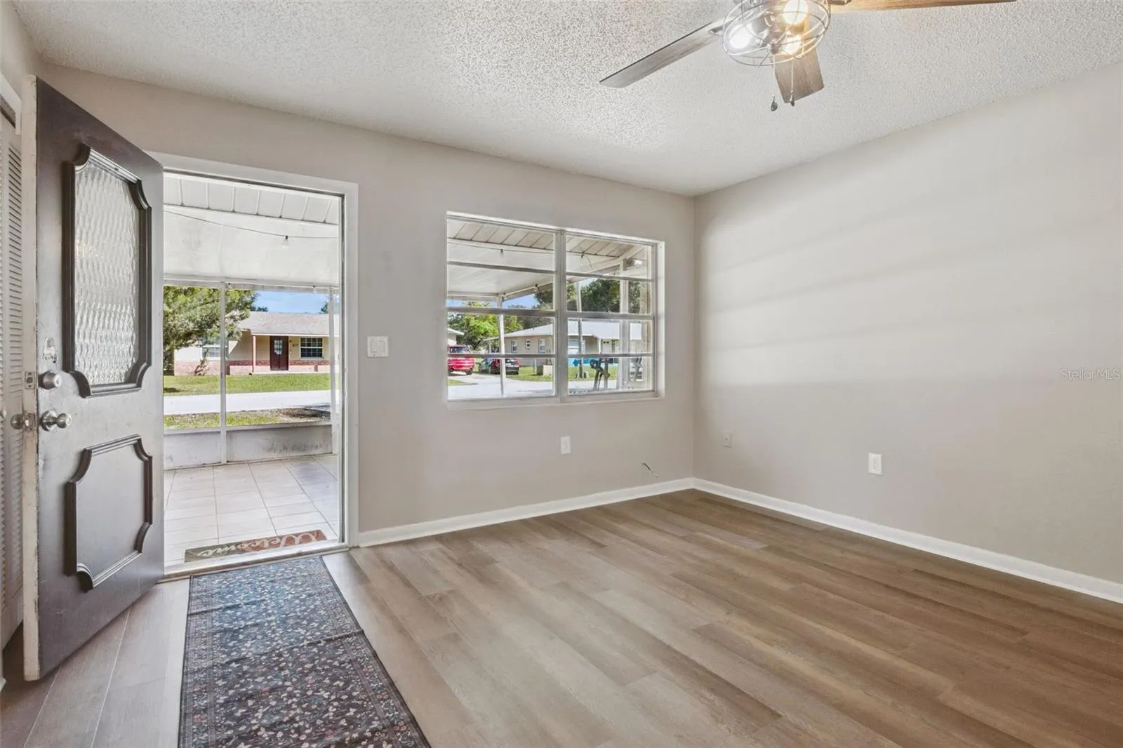 Living Room with ceiling fan and vinyl flooring.