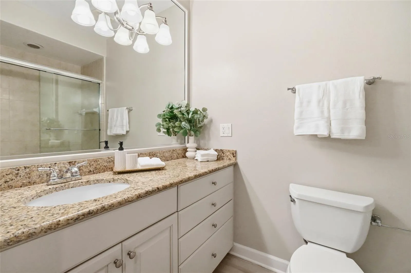 Guest bathroom has freshly painted cabinetry