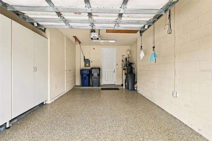 Garage has epoxy floor and storage cabinets
