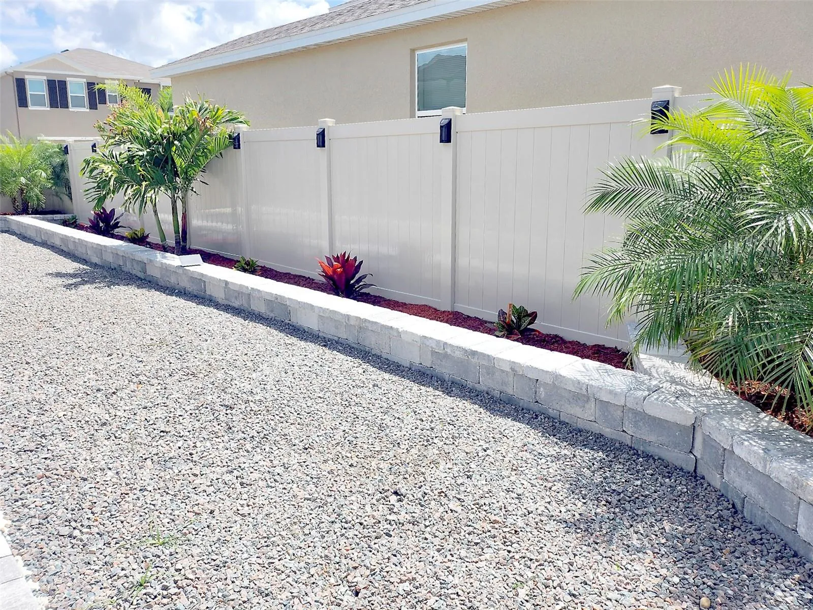 Backyard low-maintenance landscaped with decorative stone