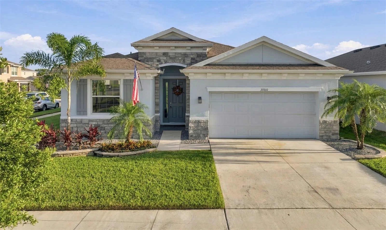 Beautiful Front Exterior with Attractive Landscaping and Extended Driveway