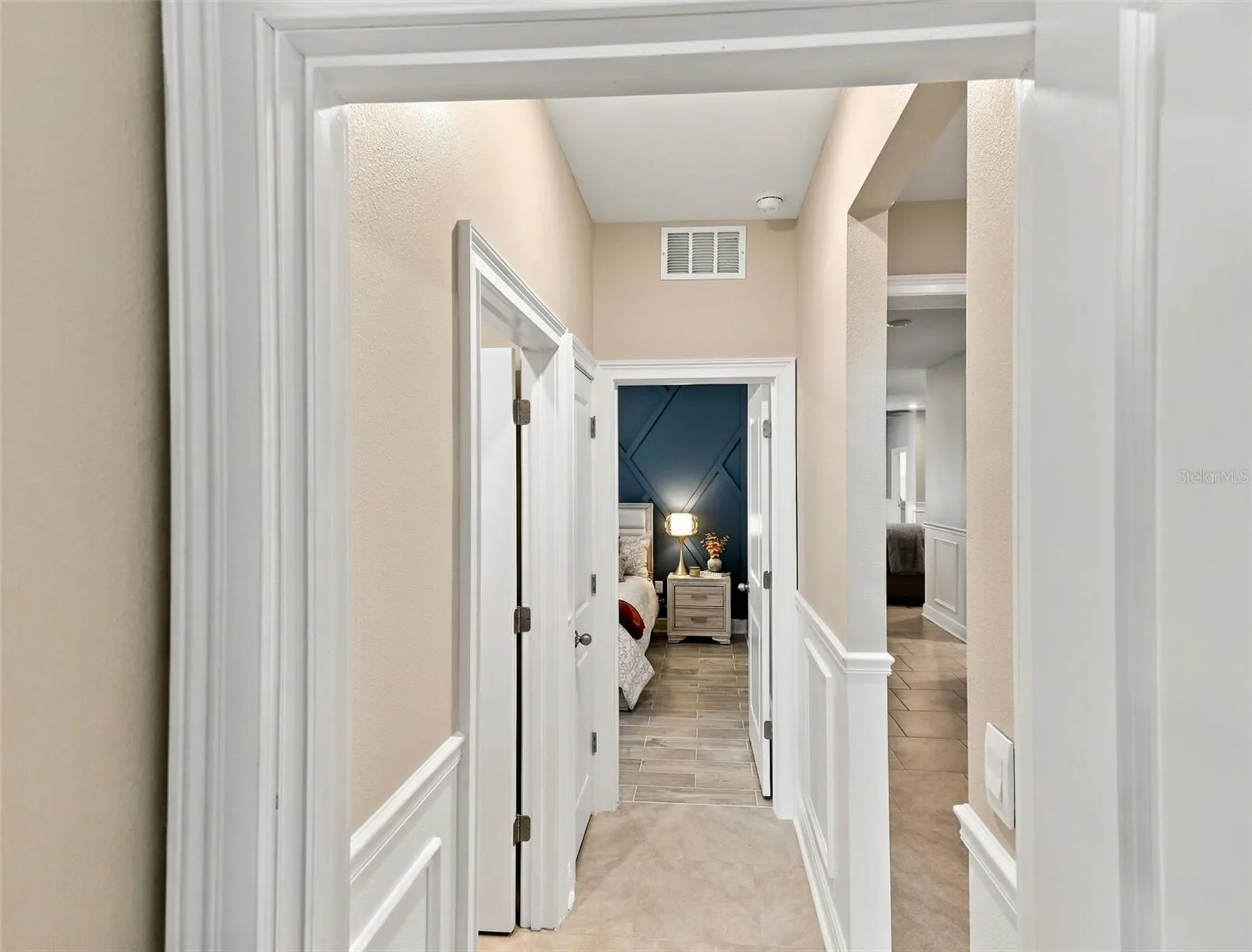 Beautiful Hallway Featuring Decorative Wall Molding and Tile Floor