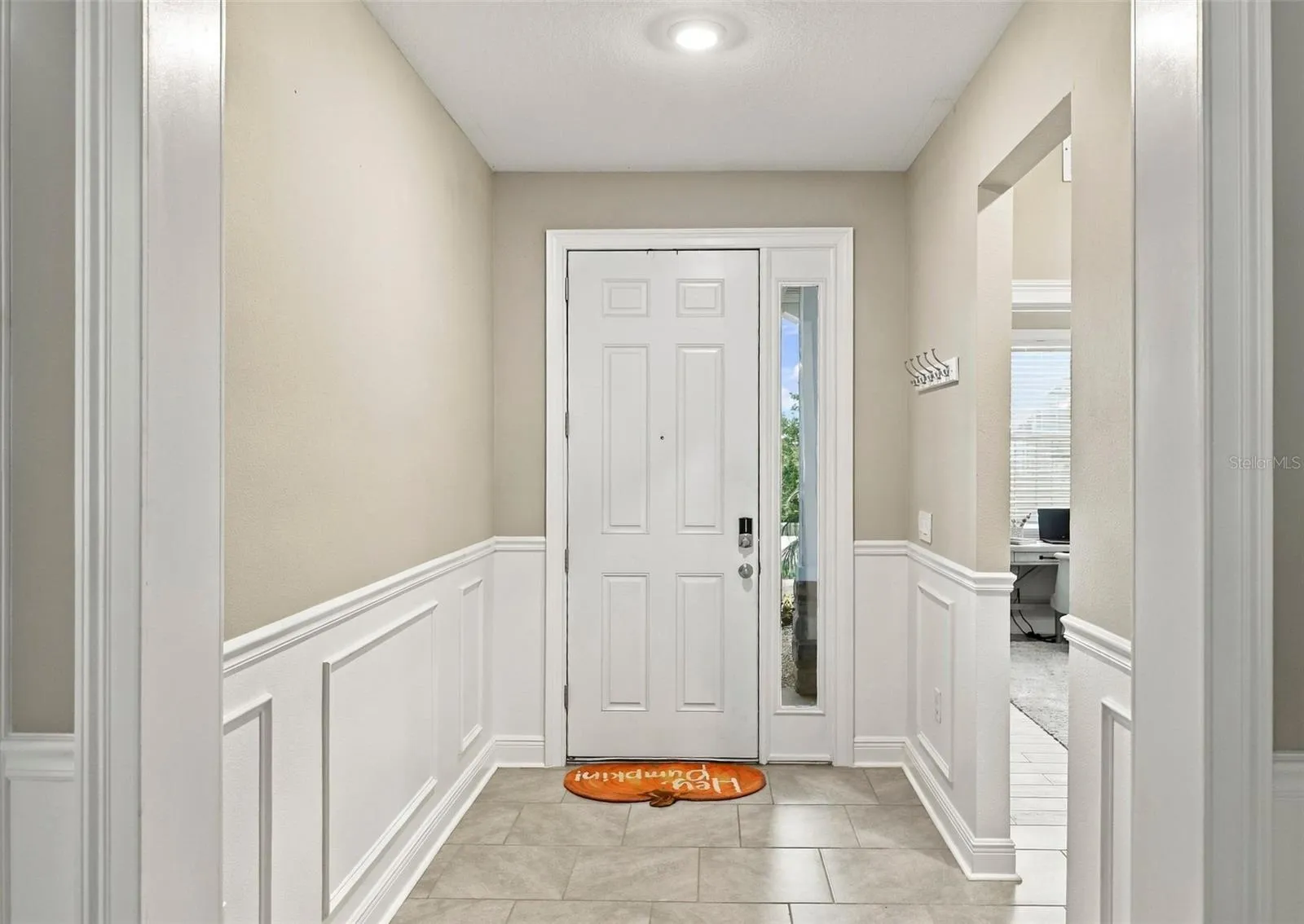 Foyer Featuring Elegant Wall Molding and Decorative trim