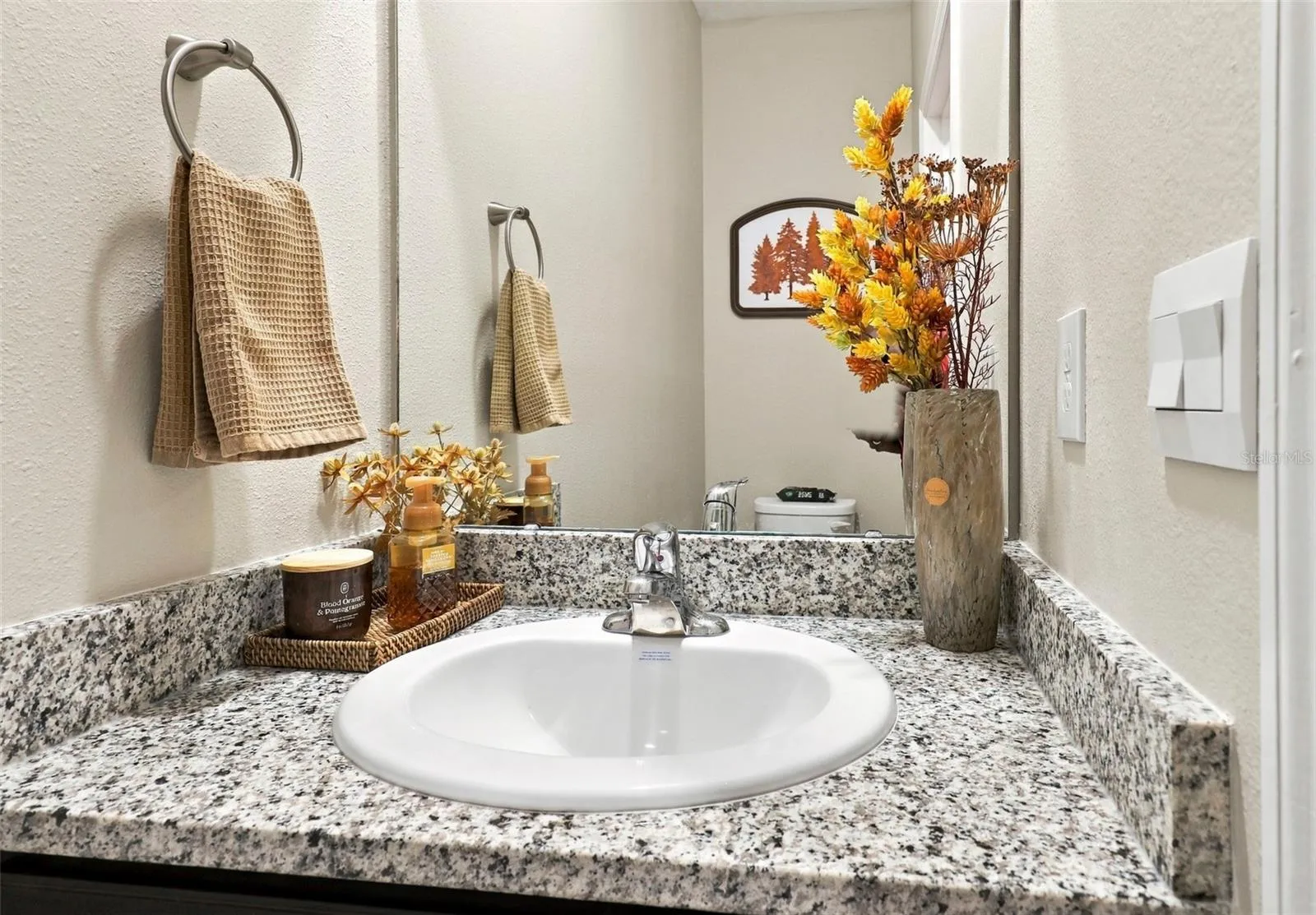 Half Bathroom Featuring Granite Style Countertop