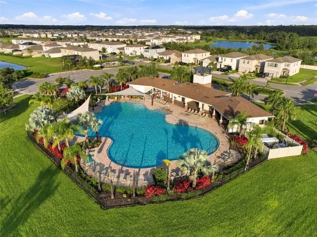 Resort- StyleCommunity Pool with Sun Deck and Lush Landscaping