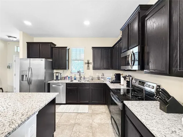 Classic espresso cabinetry, granite counters and stainless appliances