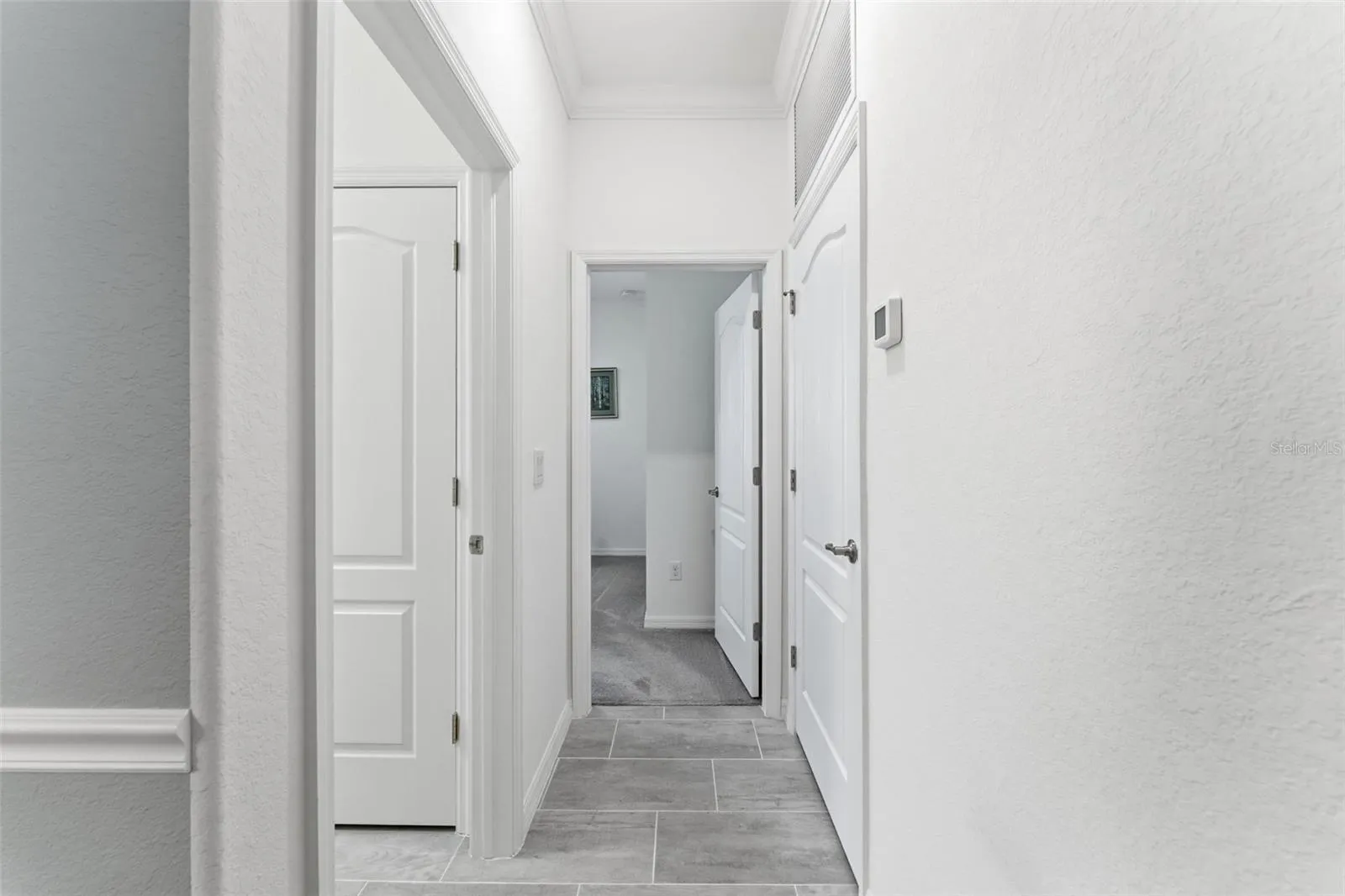 Hallway past the dining room leads to the laundry room and 4th bedroom/den