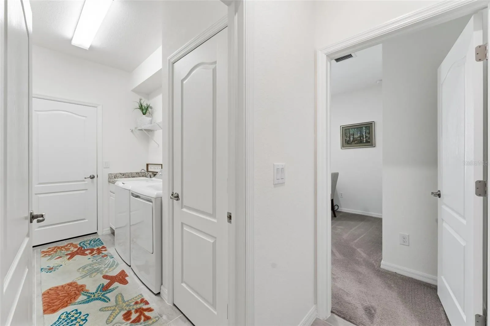 Wire shelving above appliances - door to right is 4th bedroom/den