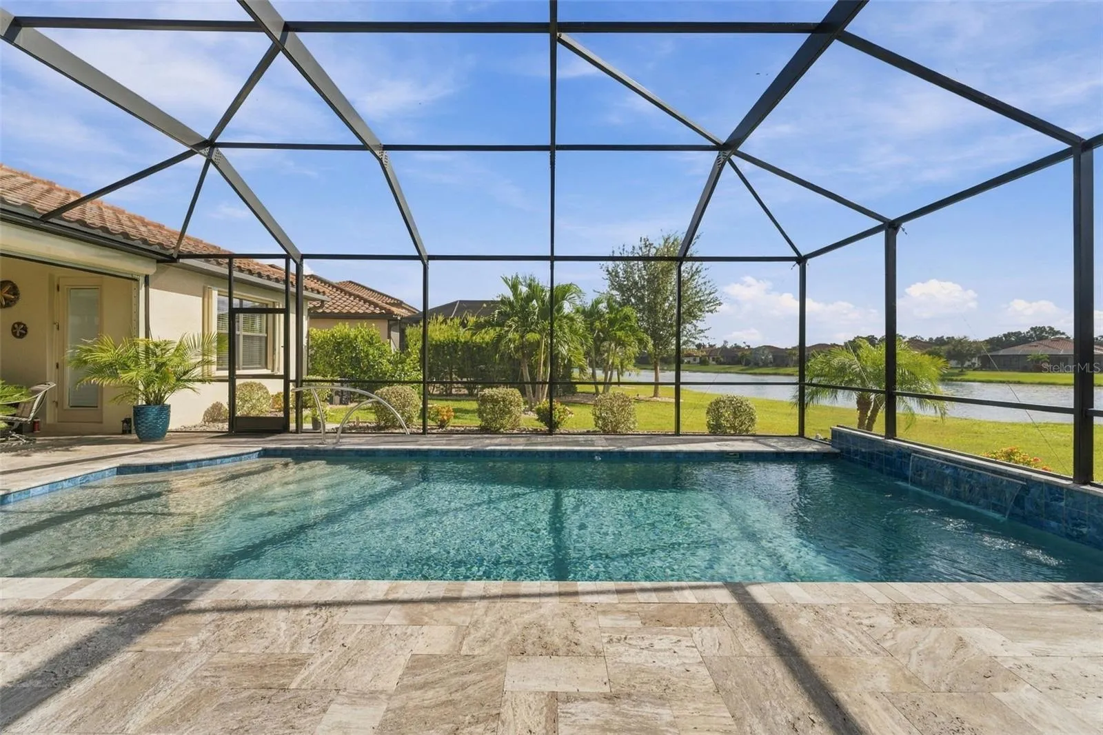 Picture yourself here...travertine deck, waterfall on the right, steps and sun shelf on the left