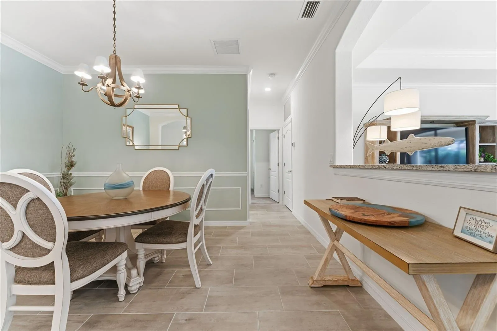 Entry-way to the right leads to laundry room and 4th bedroom/den