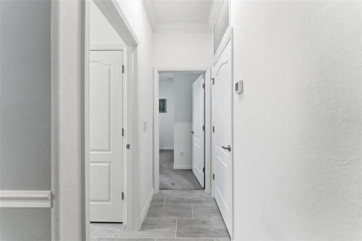 Hallway past the dining room leads to the laundry room and 4th bedroom/den
