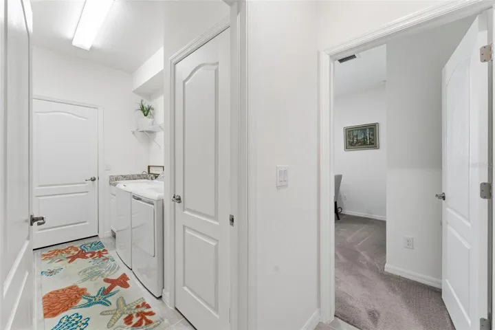 Wire shelving above appliances - door to right is 4th bedroom/den