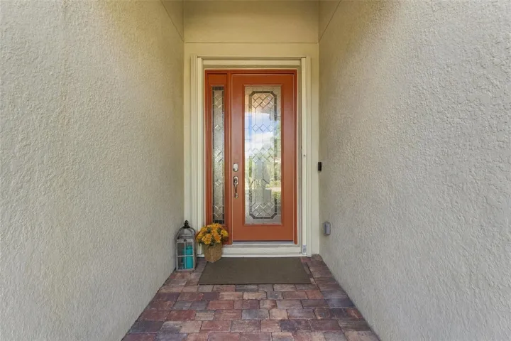 Beautiful glass front door with accordion hurricane shutters