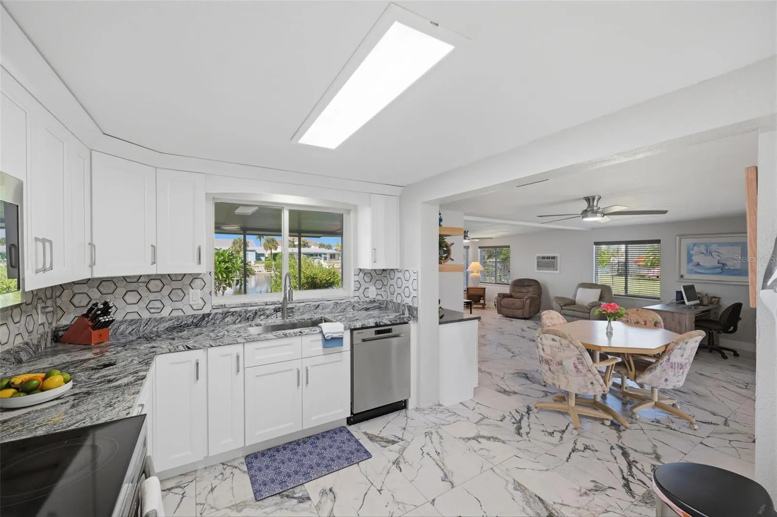 Chefs kitchen - Samsung appliance pkg.   Pass through window. Water view from kitchen sink.  Sunken family room