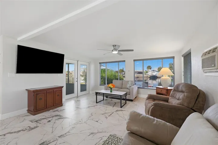 Water view from Family Room - access to the screened FL room with adjustable shades.