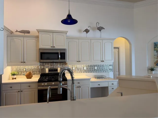 decorative metal tiles adorn the wall under cabinets
